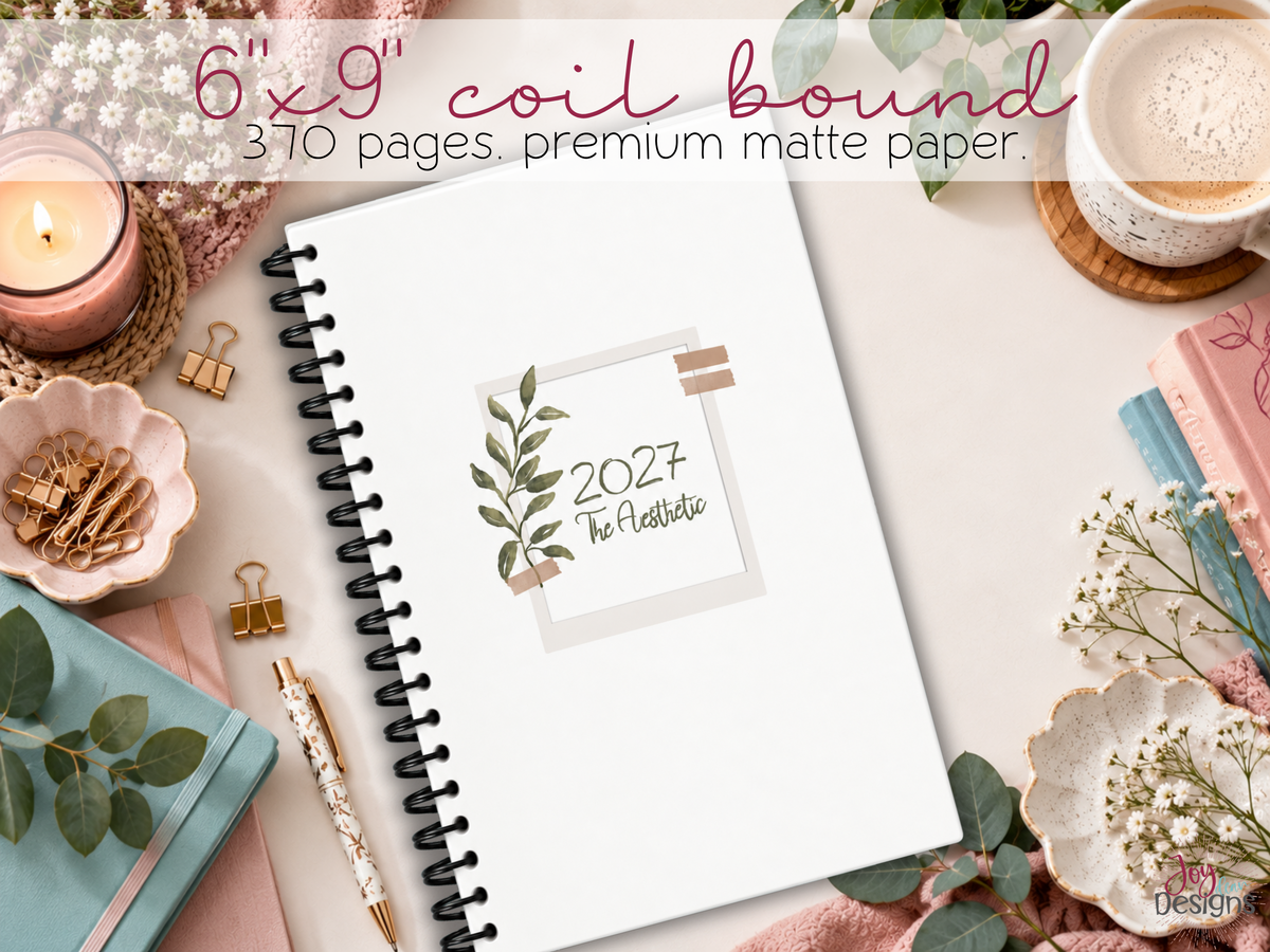 The Aesthetic 2027 physical dotted journal shown at an angle displaying minimalist botanical matte cover black plastic coil binding and portable 6x9 inch size premium white interior paper 370 page premade planner for everyday organization creative journaling habit tracking mood monitoring self care goal setting and monthly scheduling aesthetic notebook gift for women teens students and stationery lovers spiral bound dated planner with customizable layouts decorative trackers and coloring pages